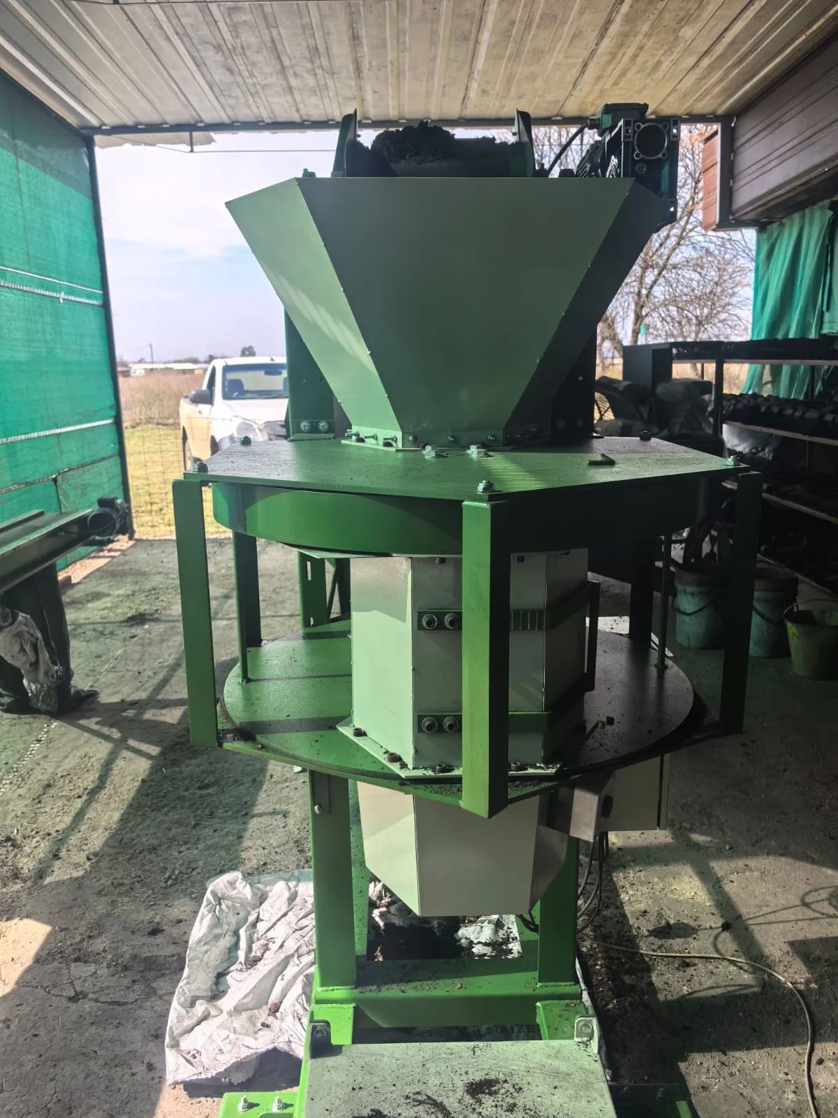 Front view of the gravity packer's feed hopper and adjustable measuring chambers