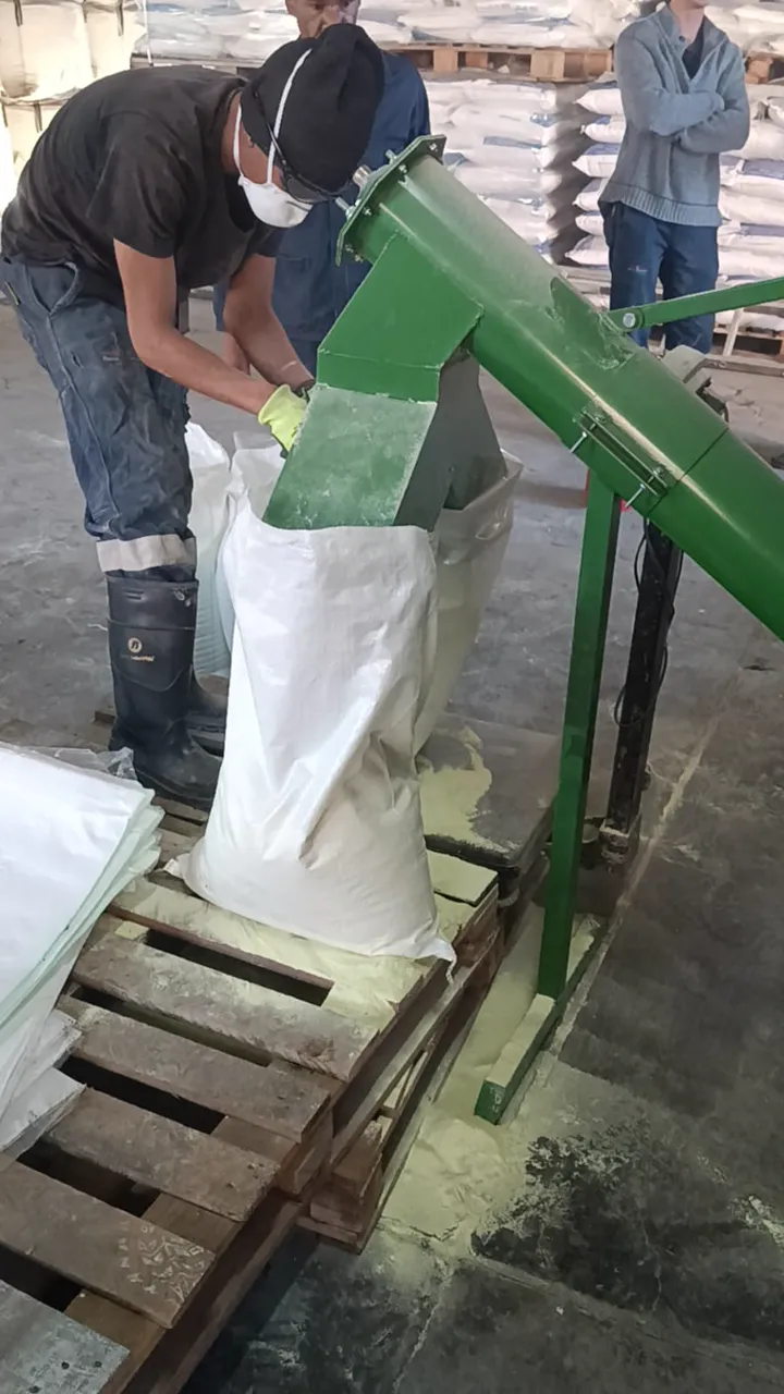 Operator bagging finished product straight off the hammer crusher discharge auger